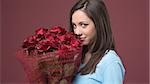 Happy young woman holding a beautiful red roses bouquet