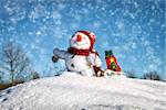 Happy snowman with hat in the snow