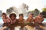 Portrait Of Children Having Fun In Outdoor Swimming Pool