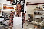 Business owner behind the counter at a sandwich bar