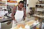 Man working behind the counter at a sandwich bar