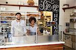 Mixed race couple behind the counter at a sandwich bar
