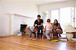 Family Unpacking Boxes In New Home On Moving Day