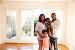 Portrait Of Family In New Home On Moving Day