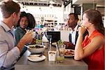 Group Enjoying Business Lunch In Delicatessen