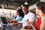 Business People Working At Counter In Coffee Shop