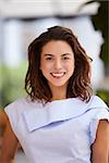 Portrait of smiling young mixed race businesswoman, vertical