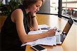 Businesswoman working in office, side view, close up