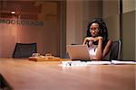 Young black businesswoman working late alone in office