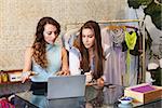 Two young women working in clothing store