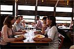 Four female friends at a girlsÕ lunch in a busy restaurant