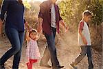 Mixed race family walking on rural path, close up side view
