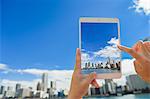 Japanese woman using augumented reality app on tablet downtown Tokyo, Japan