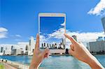 Japanese woman using augumented reality app on tablet downtown Tokyo, Japan