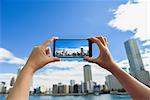 Japanese woman using augumented reality app on smartphone downtown Tokyo, Japan