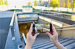 Japanese woman using augumented reality app on smartphone downtown Tokyo, Japan