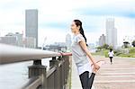 Attractive Japanese woman training by a river downtown Tokyo, Japan