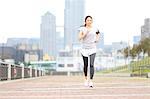 Attractive Japanese woman training by a river downtown Tokyo, Japan