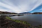 Night view of cloudy sky and Mount Fuji at night from Lake Yamanaka, Yamanashi Prefecture, Japan