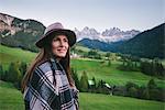 Woman looking into distance, Santa Maddalena, Dolomite Alps, Val di Funes (Funes Valley), South Tyrol, Italy