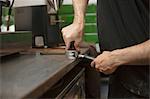 Male barista's hands preparing coffee machine in cafe