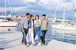 Young couples strolling on harbour, Split, Dalmatia, Croatia