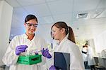 Scientists in laboratory discussing samples