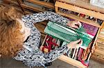 Owner of small fashion business working in material storeroom