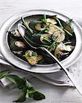 Bistro table with bowl of buttered courgettes, mint and green beans