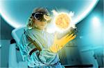 Boy in virtual reality headset interacting with digital floating sun