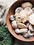 Overhead view of silver Christmas baubles and fresh cookies in bowl