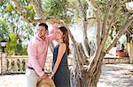 Couple by olive tree in boutique hotel garden, Majorca, Spain
