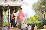 Couple with champagne on boutique hotel patio, Majorca, Spain