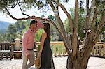 Couple talking in garden at boutique hotel, Majorca, Spain