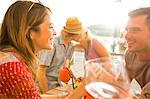 Couple chatting at waterfront restaurant, Majorca, Spain