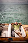 Portrait of a mature adult man relaxing on a boat.