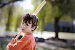 Portrait of a boy holding a baseball bat.
