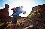 Energetic young man hiking in a canyon.