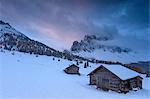 Pink clouds at dawn on the Odle and hut covered with snow, Malga Caseril,  Funes Valley, South Tyrol, Dolomites, Italy, Europe