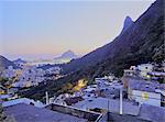 Twilight view of the Favela Santa Marta with Corcovado and the Christ statue behind, Rio de Janeiro, Brazil, South America