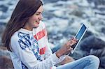 Girl with digital tablet on beach