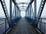 Pedestrian bridge in fog