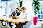 Businesswoman and man looking at digital tablet in  office meeting