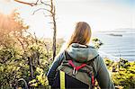 Female hiker looking out from coastal forest, Pacific Rim National Park, Vancouver Island, British Columbia, Canada