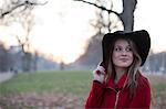 Young woman in floppy hat in park, London, UK