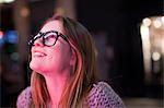 Young woman enjoying bright neon lights of street, London, UK