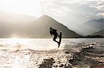 Silhouette of waterskier waterskiing, Maggiore lake, Verbania, Piedmont, Italy