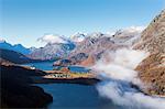 View of Sils and the blue lake surrounded by mist in autumn, Surlej, St. Moritz, Canton of Graubunden, Engadine, Switzerland, Europe