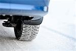 Close-up Image of Winter Car Tire on the Snowy Road. Drive Safe Concept.