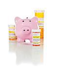 Piggy Bank and Non-Proprietary Medicine Prescription Bottles Isolated on a White Background.